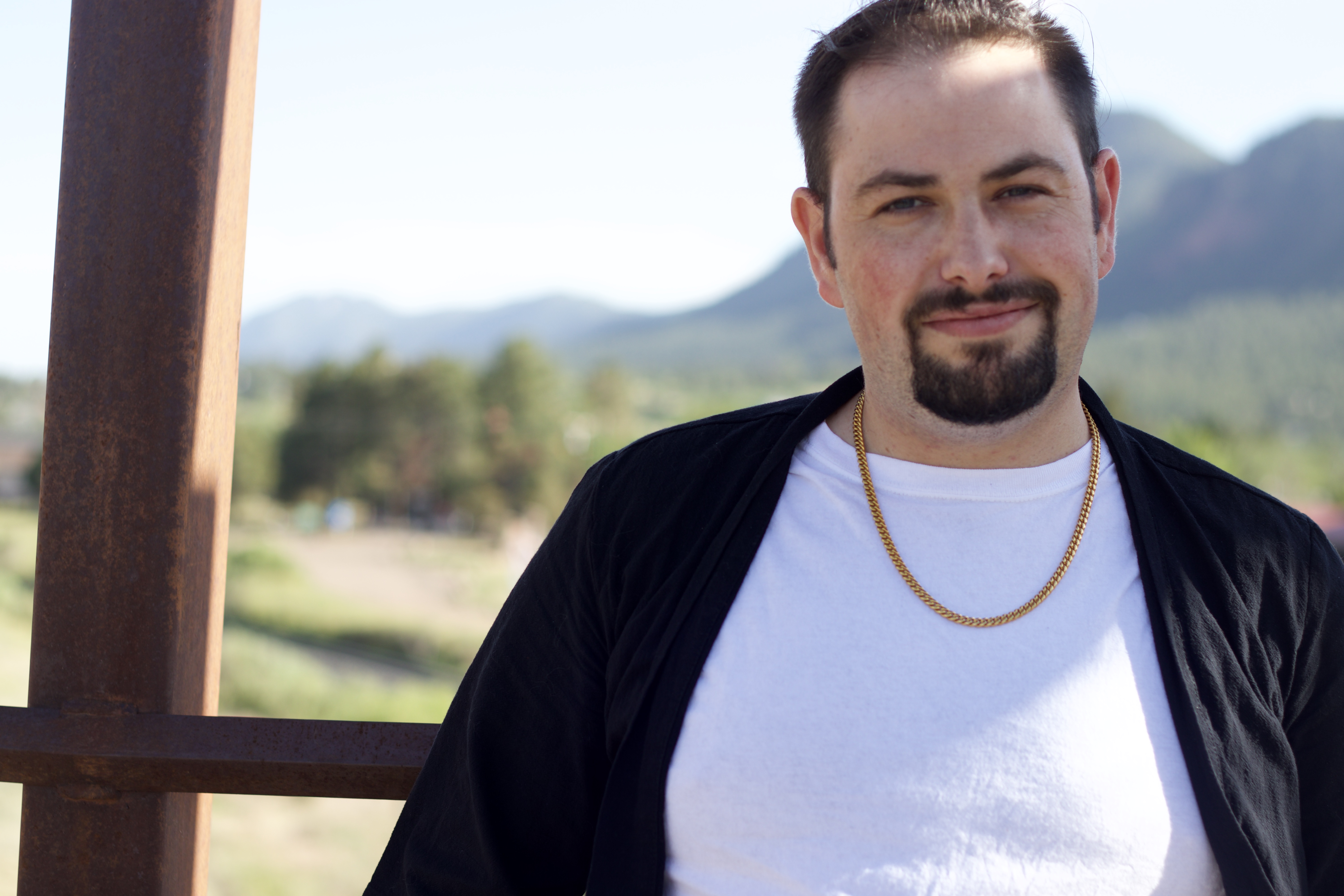 Michael Perry standing outdoors in a mountain landscape